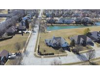 A beautiful aerial view of a neighborhood featuring a large pond and well-maintained lawns at 6897 Abercon Trl, Noblesville, IN 46062
