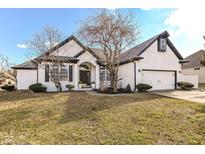 Charming white brick home featuring black accents, an attached two car garage, and tidy landscaping at 6897 Abercon Trl, Noblesville, IN 46062