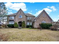 Charming two-story brick home with manicured landscaping and a welcoming entrance at 897 Copperwood Dr, Carmel, IN 46033