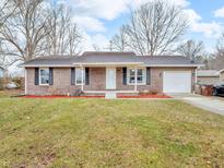 Charming brick ranch-style home featuring an attached garage, well-maintained lawn, and cozy front porch at 12386 S Hillview Dr, Columbus, IN 47201