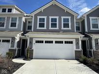 Charming townhome featuring a two-car garage and a neatly landscaped front yard at 1257 Newton St, Avon, IN 46123