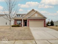 Charming single-Gathering home featuring brick accents, a two-car garage, and a well-maintained lawn at 1966 Silverberry Dr, Indianapolis, IN 46234
