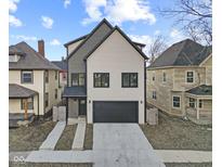 Modern two-story home featuring a two-car garage and concrete driveway at 2406 Carrollton Ave, Indianapolis, IN 46205