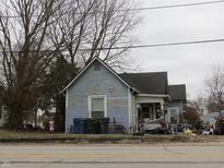 Exterior view of a two-story home with weathered siding and an overgrown front yard at 250 S Marion St, Morgantown, IN 46160