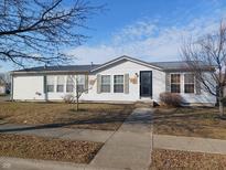 Charming single-story home featuring white siding and a neatly maintained front lawn at 3336 Fall Valley Dr, Columbus, IN 47203
