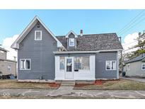 Charming two-story home with gray siding, dormer windows, and landscaped front yard at 516 W Washington St, Lebanon, IN 46052