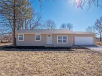 Charming ranch-style home featuring a one-car garage, manicured lawn and mature trees at 5197 Oakridge Dr, Mooresville, IN 46158