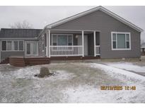 Charming single-story home with a covered porch, gray siding, and a well-maintained front yard at 5820 N Nebo Rd, Muncie, IN 47304
