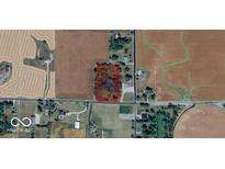 Aerial view of potential land to develop on surrounded by mature trees and accessible paved roads at 6944 E 300 S, Greenfield, IN 46140
