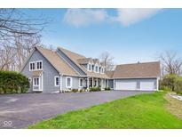 Spacious home with three-car garage, light-blue siding, and well-manicured lawn and mature trees at 8015 Sargent Rdg, Indianapolis, IN 46256