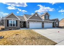 Beautiful home showcasing a well-manicured lawn, driveway, attached garages, and appealing architectural features at 1684 Hedley W Way, Avon, IN 46123