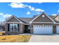 Charming brick home with attached two car garage, neat landscaping, and classic architectural details at 1684 Hedley W Way, Avon, IN 46123