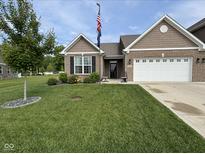 Well-maintained, single-story home with a lush front yard, brick facade, and attached two car garage at 1684 Hedley W Way, Avon, IN 46123