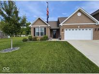 Charming single-story home boasts a well-manicured lawn and an inviting two-car garage at 1684 Hedley W Way, Avon, IN 46123