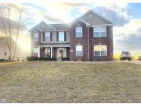 Charming two-story home featuring a brick and vinyl facade with well-maintained landscaping at 254 Halldale Dr, Whiteland, IN 46184