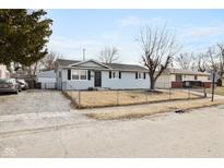 Charming single-story home featuring a fenced yard and detached garage at 2803 Dietz St, Indianapolis, IN 46203
