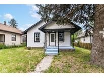 Charming home featuring a covered front porch, freshly painted trim, and a cozy entrance at 2815 Meredith Ave, Indianapolis, IN 46201