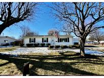 Charming single-story home featuring an American flag, manicured shrubs, and lovely curb appeal at 356 Parkview Dr, Whiteland, IN 46184