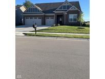 Charming brick home featuring a well-manicured lawn, two-car garage, and classic architectural details at 3613 Chalmers Dr, Bargersville, IN 46106