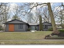 Charming single-story home featuring sleek, modern exterior and well-manicured lawn at 3707 Chadwick Dr, Carmel, IN 46033