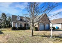 Charming home featuring brick, dormers, two-car garage, landscaping, and a mature tree in the front yard at 4815 Countrybrook Way, Indianapolis, IN 46254