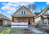 Charming home featuring a covered front porch, wood accents, and a well-maintained yard at 544 N Parker Ave, Indianapolis, IN 46201