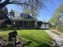 Charming two-story home with well-maintained lawn and landscaping, detached garage, and gravel drive at 5533 Wilson Way, Jamestown, IN 46147