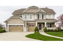 Charming two-story home with a three-car garage and manicured lawn at 12624 Teaberry Ln, Carmel, IN 46032