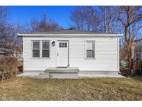 A cozy, quaint home featuring a white exterior, well-maintained lawn and welcoming front entrance at 1323 S Ewing St, Indianapolis, IN 46203