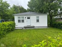 Charming single story home with mature trees and a well maintained lawn at 1323 S Ewing St, Indianapolis, IN 46203