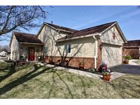 Charming single-story home with a landscaped front yard, red door and attached two car garage at 1939 Crystal Bay E Dr, Plainfield, IN 46168