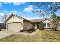 Charming single-Gathering home featuring a well-maintained lawn, attached garage, and inviting front entryway at 2130 Crossford Way, Indianapolis, IN 46234