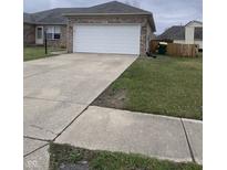 Front exterior view featuring a two-car garage, brick facade, and a concrete driveway at 2141 Galaxy Dr, Franklin, IN 46131