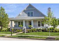 Charming two-story home with manicured lawn, stone chimney, and inviting front porch in a well-kept neighborhood at 2274 Finchley Rd, Carmel, IN 46032