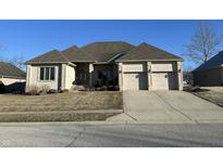 Beautiful brick home with a two-car garage and well-manicured lawn at 286 S Woodridge Dr, Pittsboro, IN 46167