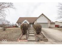 Charming home with a brick and siding exterior, landscaped front yard, and inviting entryway steps at 2888 Prairie Stream Way, Columbus, IN 47203