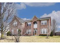 Charming two-story brick home with a well-manicured lawn and beautiful architectural details at 3229 Autumn Ash Dr, Zionsville, IN 46077