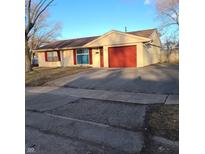 Cozy single-story home featuring a red garage door and well-maintained front yard at 3841 Monica Ct, Indianapolis, IN 46226