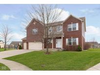 Charming brick two-story home boasts an attached garage and a well-maintained lawn at 6333 Silver Moon Ct, Indianapolis, IN 46259