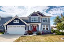 Charming two-story home with a combination of navy and gray siding and a red front door at 6481 W Treeline Ln, McCordsville, IN 46055