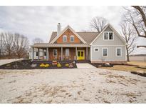 Charming two-story home featuring a cozy front porch and bright, eye-catching yellow front door at 695 N 650 W, Lebanon, IN 46052