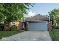 Charming single-story brick home with a well-maintained lawn and an attached two-car garage at 7013 Ringtail Ct, Indianapolis, IN 46254