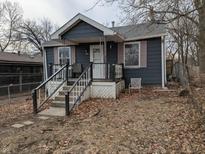 Charming home with a cozy front porch and mature trees in a quiet neighborhood at 730 Waldemere Ave, Indianapolis, IN 46241