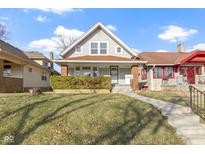 Charming two-story home with a well-maintained front yard and inviting walkway to the front door at 766 N Bancroft St, Indianapolis, IN 46201