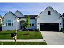 Charming two-story home featuring a manicured lawn, black garage door, and modern architectural details at 804 Whispering Oaks Dr, Carmel, IN 46032