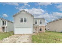 Charming two-story home featuring a front-facing garage and a neatly maintained lawn at 8444 Ash Grove Dr, Camby, IN 46113