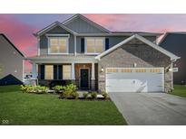 Charming two-story home with gray siding, brick accents, a two-car garage, and well-maintained landscaping at 9034 Faulkner Dr, Indianapolis, IN 46239