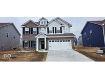 Charming two-story home featuring a mix of brick and siding, a two-car garage, and a well-maintained front yard at 10202 Meadow Path Ln, Indianapolis, IN 46239