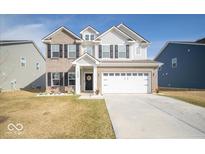Inviting two-story home showcasing a well-manicured lawn and attached two-car garage at 10202 Meadow Path Ln, Indianapolis, IN 46239
