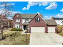 Charming two-story home with brick accents, a three-car garage, and well-maintained landscaping at 10518 Cornelian Ct, Noblesville, IN 46060